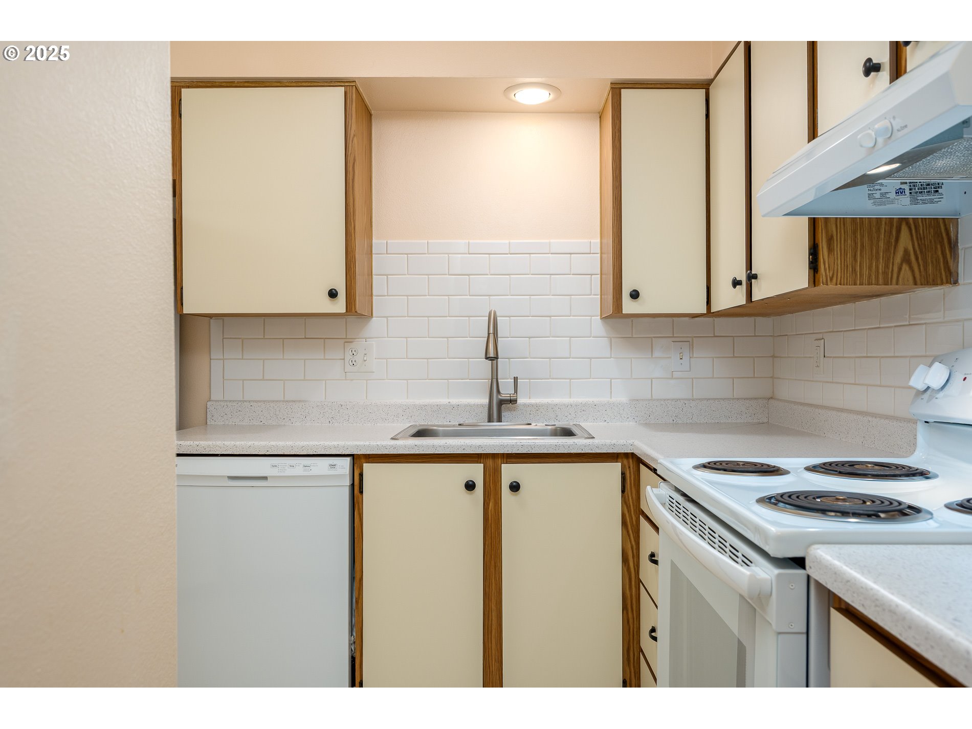 14828 Southwest 109th Avenue Portland, OR 97224 - Photo 15 of 40 a kitchen with stainless steel appliances granite countertop a sink stove and cabinets