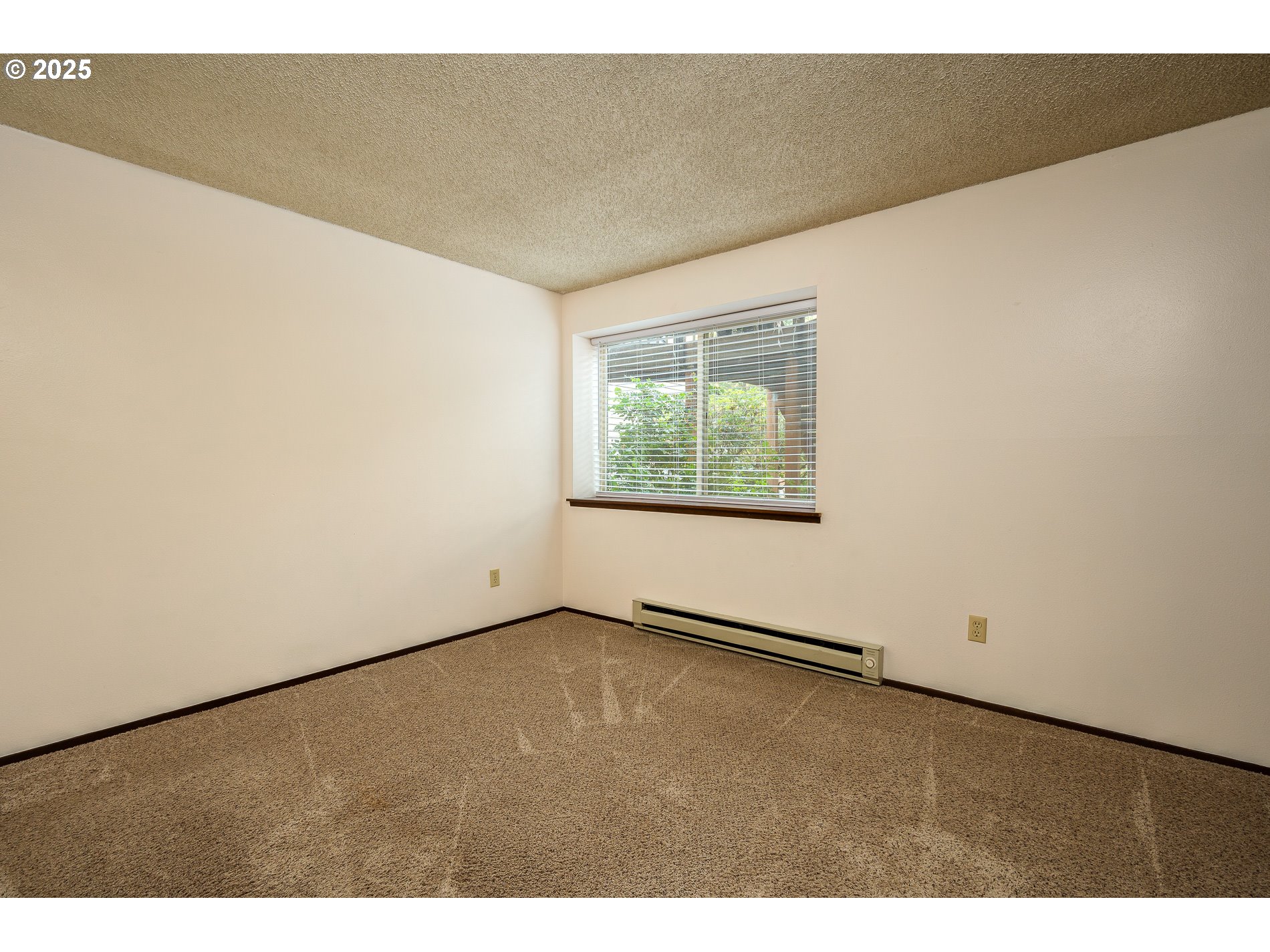 14828 Southwest 109th Avenue Portland, OR 97224 - Photo 22 of 40 a view of an empty room with wooden floor and a window