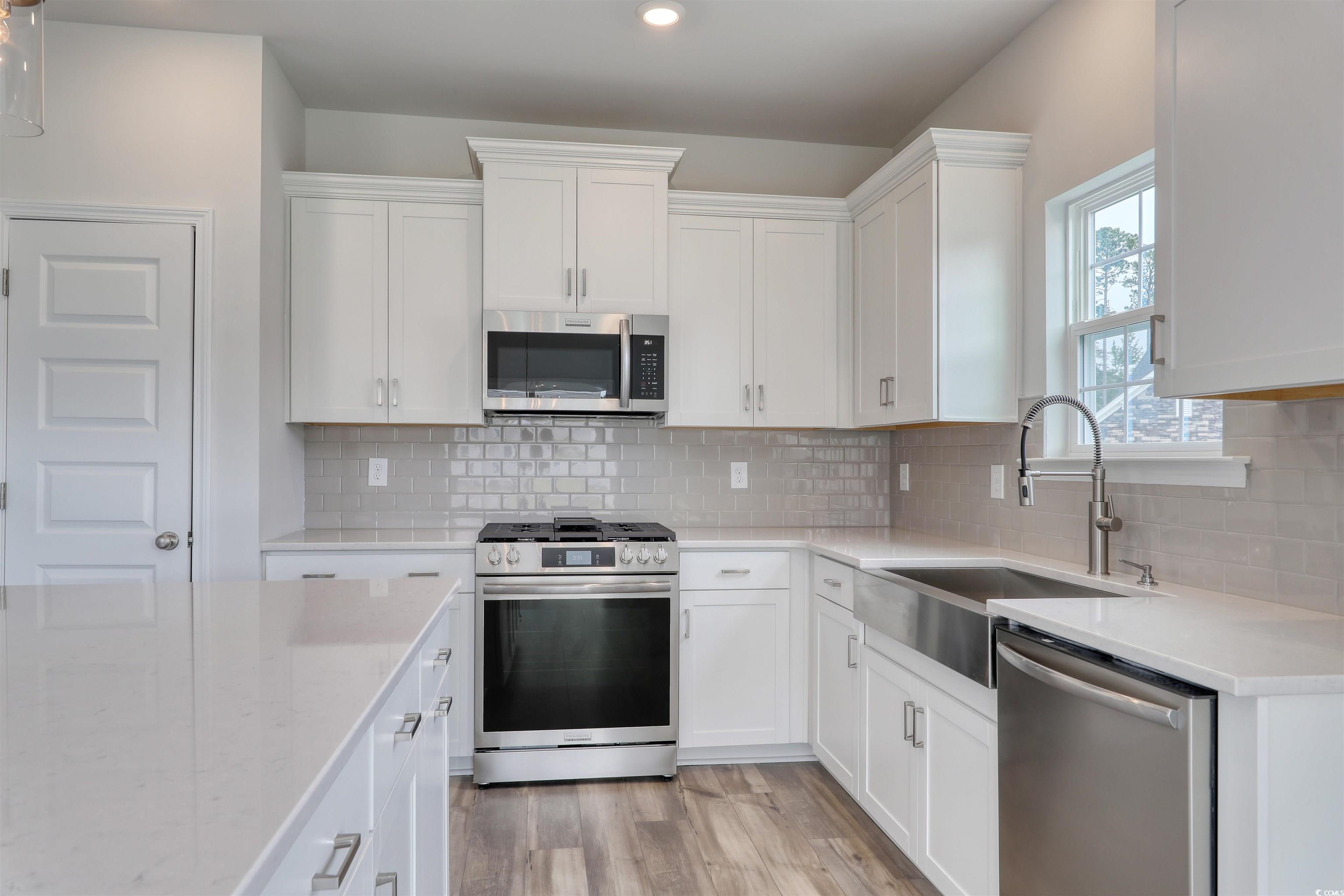 127 Azure Loop Myrtle Beach, SC 29588 - Photo 16 of 39 Kitchen featuring tasteful backsplash, sink, white