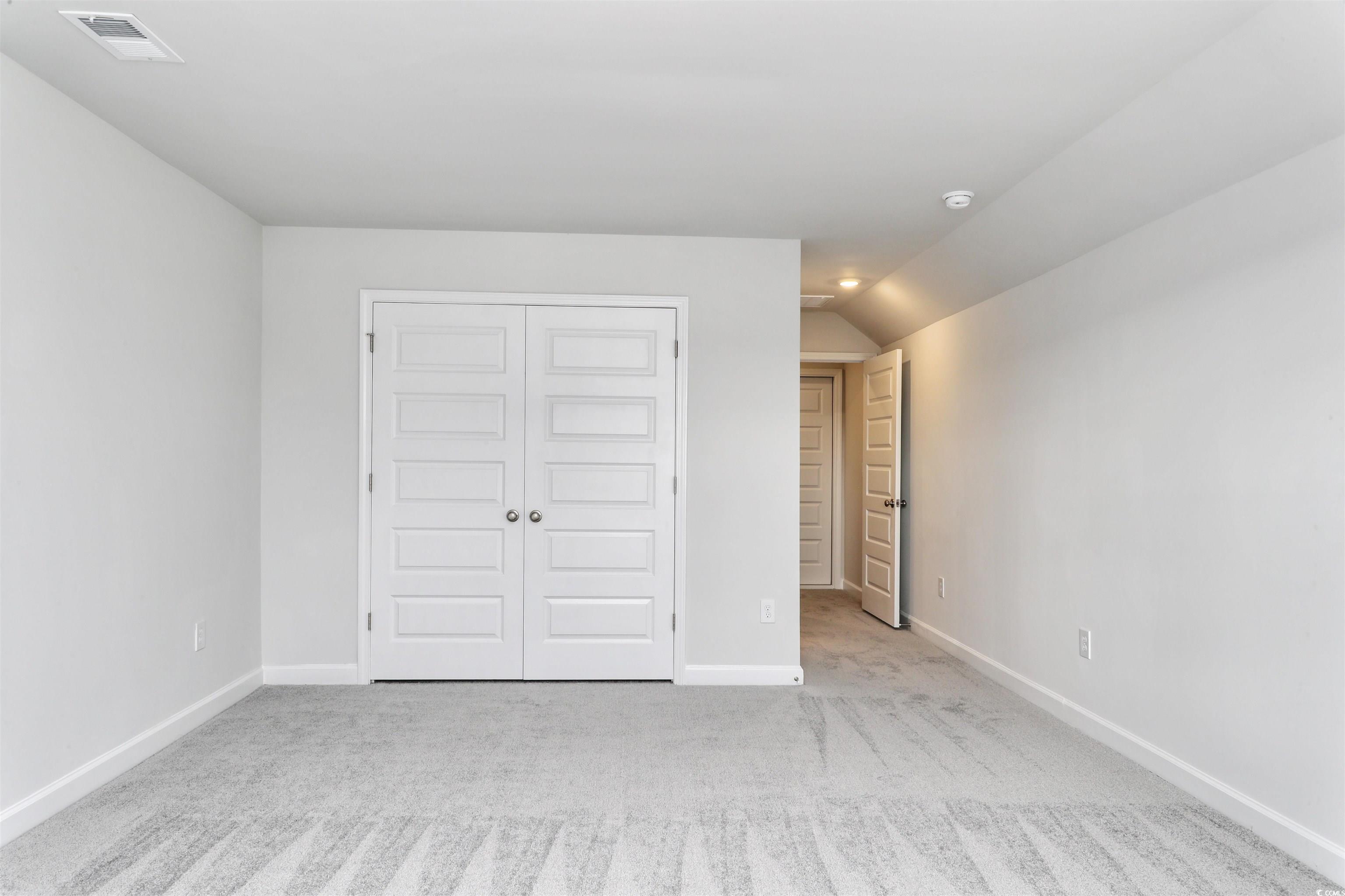 127 Azure Loop Myrtle Beach, SC 29588 - Photo 26 of 39 Unfurnished bedroom with lofted ceiling, light car