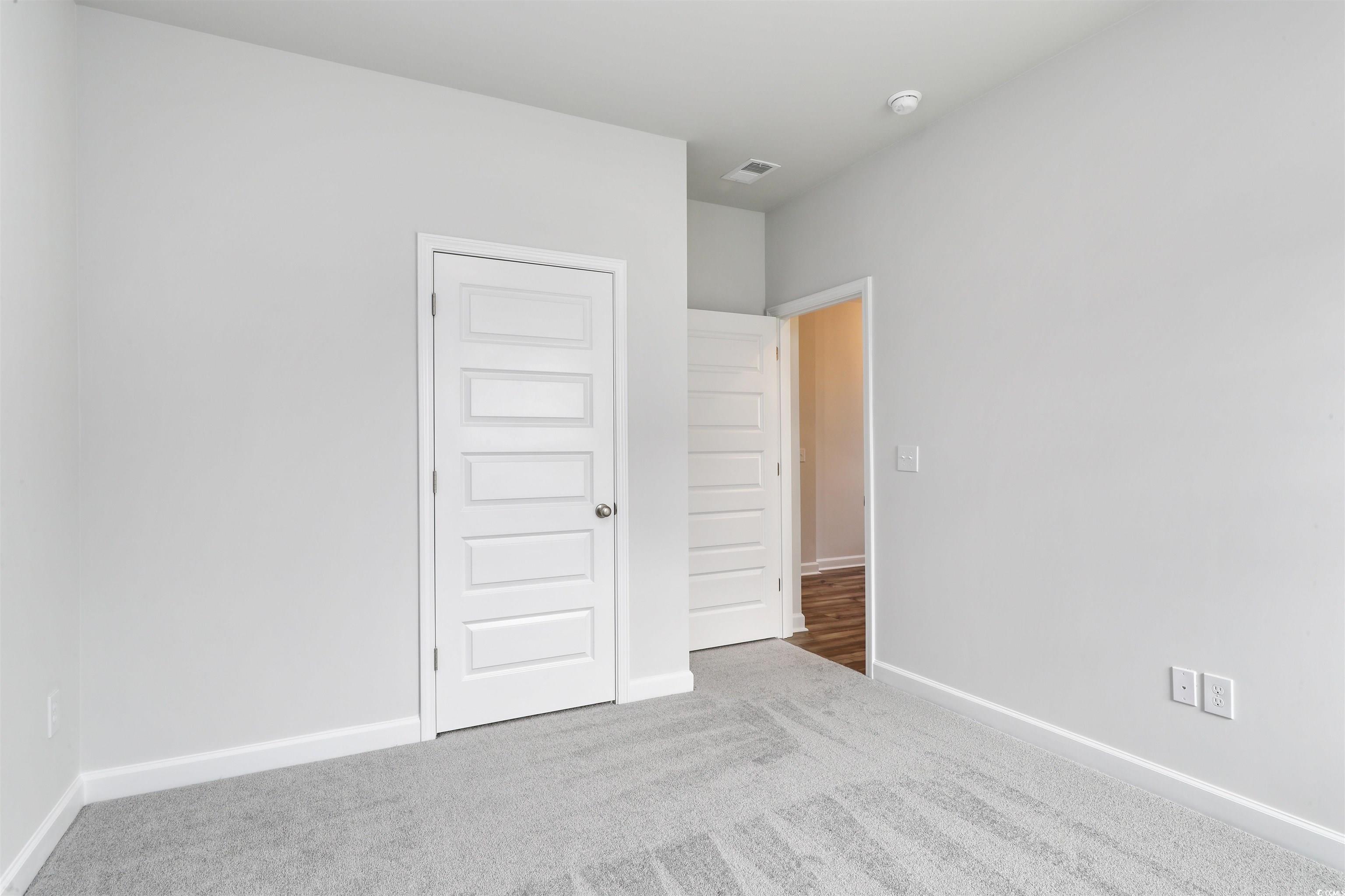 127 Azure Loop Myrtle Beach, SC 29588 - Photo 9 of 39 Unfurnished bedroom featuring a closet and carpet
