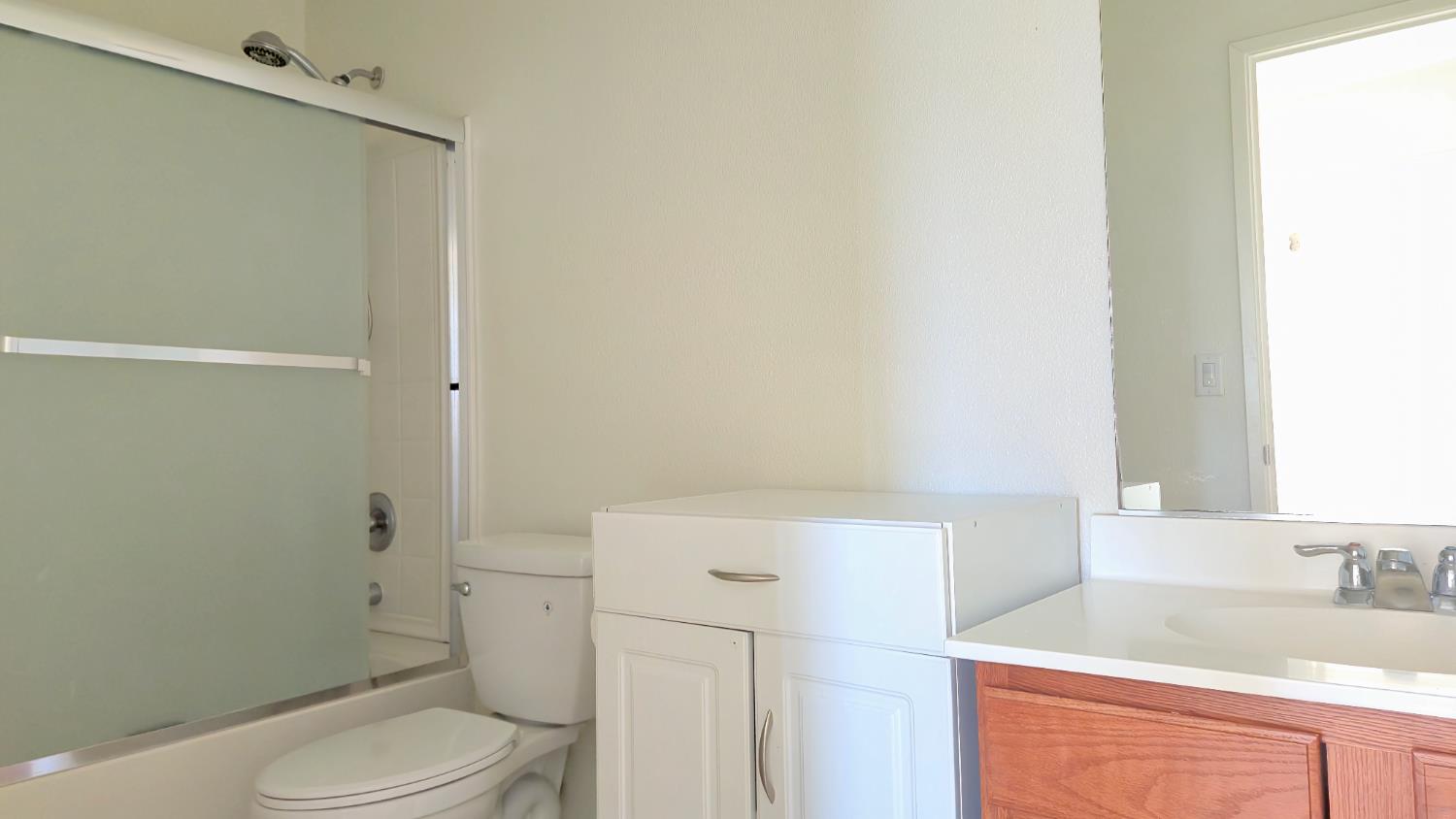 758 Persimmon Street Madera, CA 93638 - Photo 19 of 32 a bathroom with a sink a toilet and shower