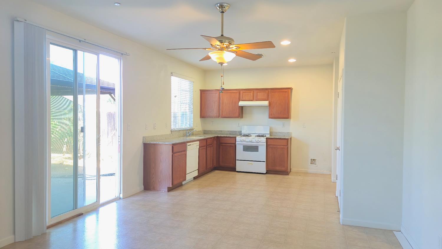 758 Persimmon Street Madera, CA 93638 - Photo 5 of 32 a kitchen with stainless steel appliances a window and cabinets