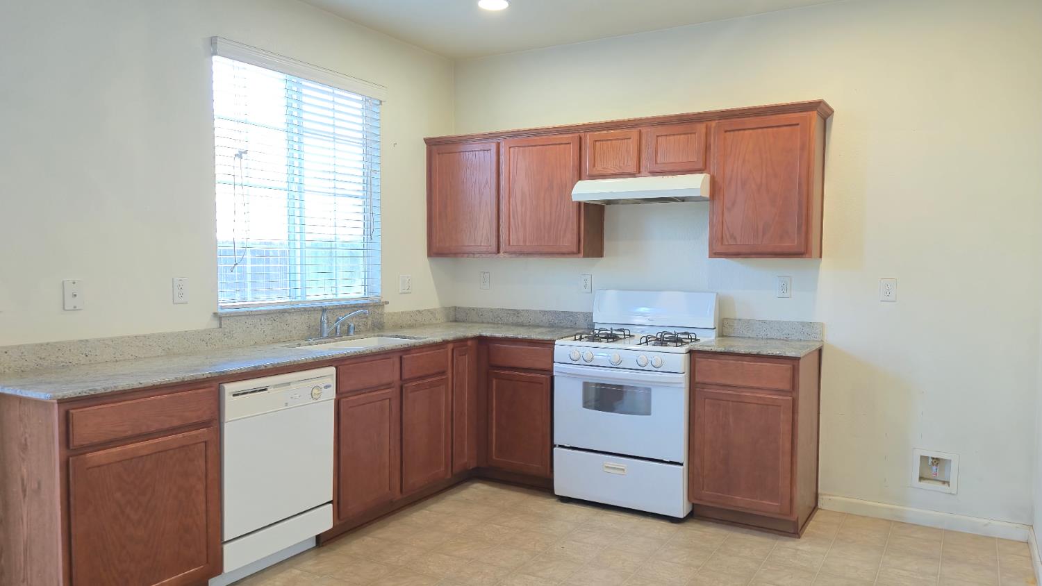 758 Persimmon Street Madera, CA 93638 - Photo 6 of 32 a kitchen with a sink stove and cabinets