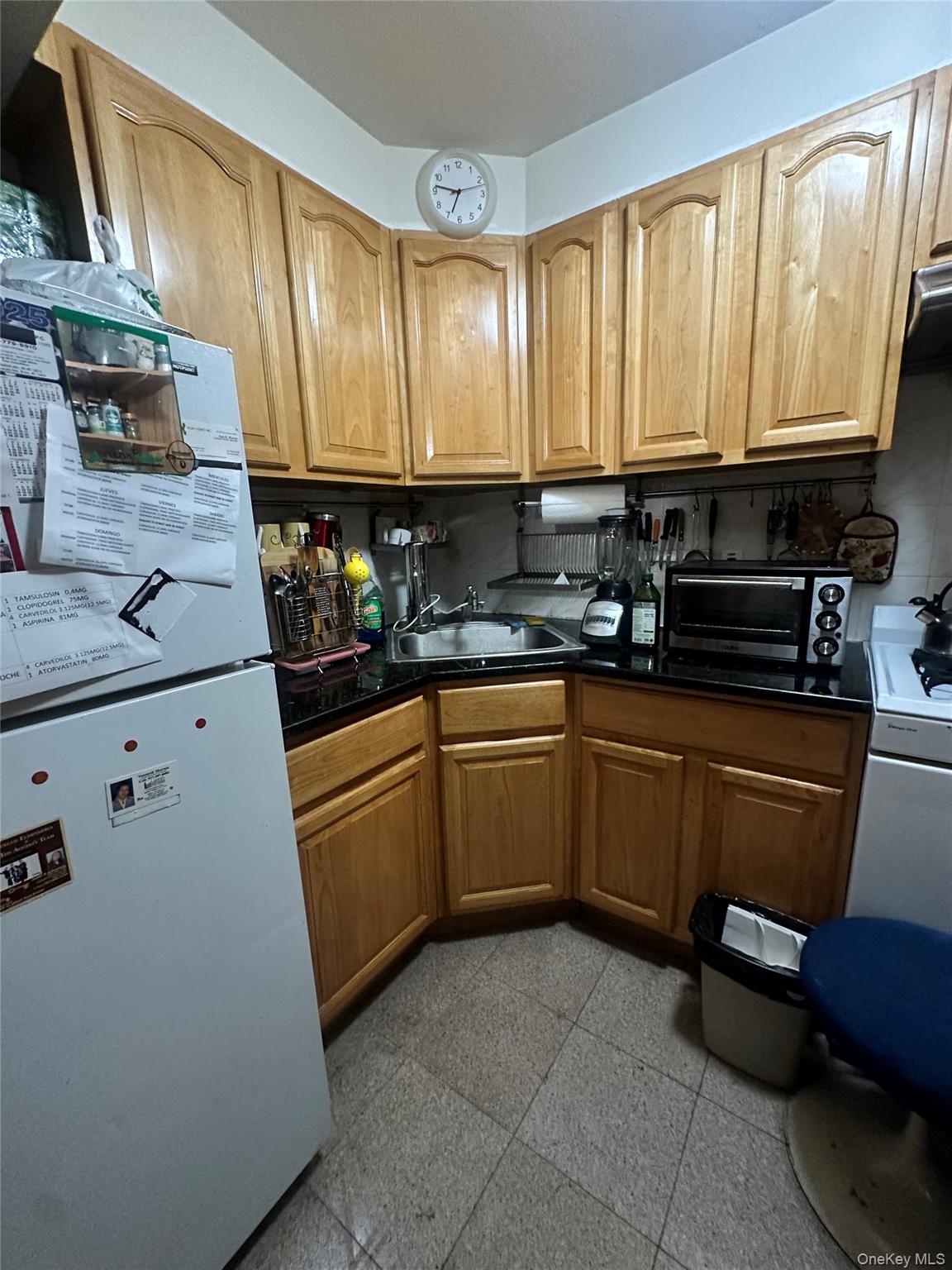 40-24 76th Street, Unit 3B Queens, NY 11373 - Photo 4 of 9 a kitchen with a sink a stove and cabinets
