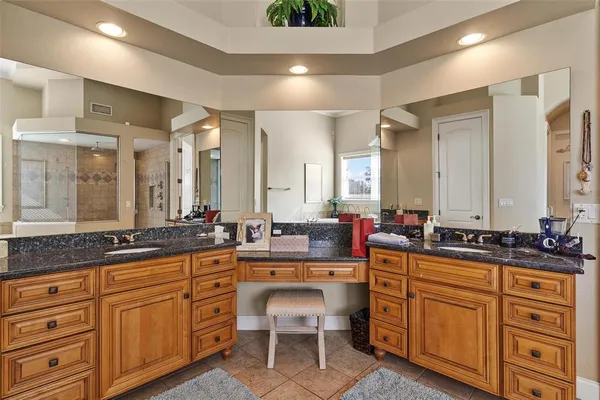 a bathroom with a granite countertop sink toilet and a mirror