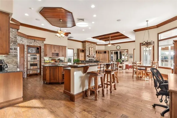 a living room with furniture a chandelier and a window