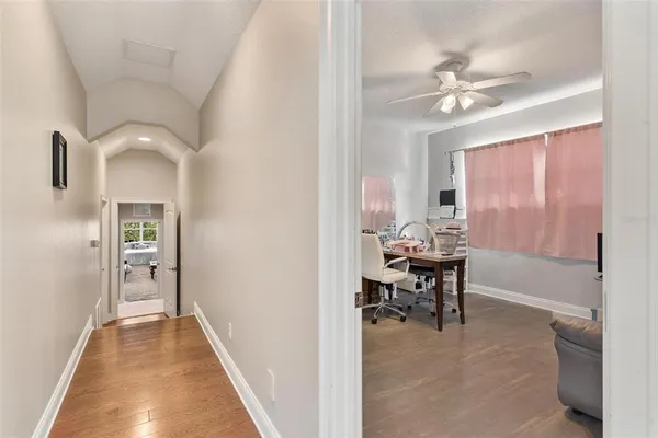 an aerial view of a house with yard and green space
