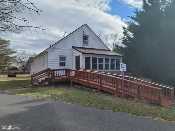 a view of a house with a wooden deck