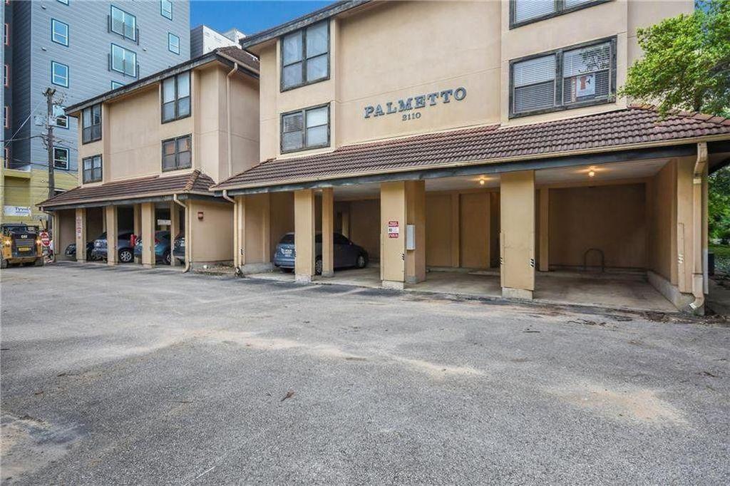 2110 Rio Grande Street, Unit 303 Austin, TX 78705 - Photo 7 of 7 Covered parking offers convenience beneath this multi-story residence with a tile roof.