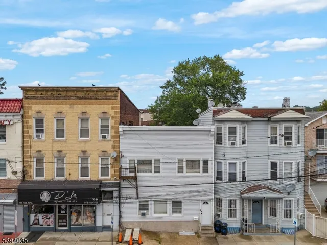 a front view of a residential apartment building with a yard