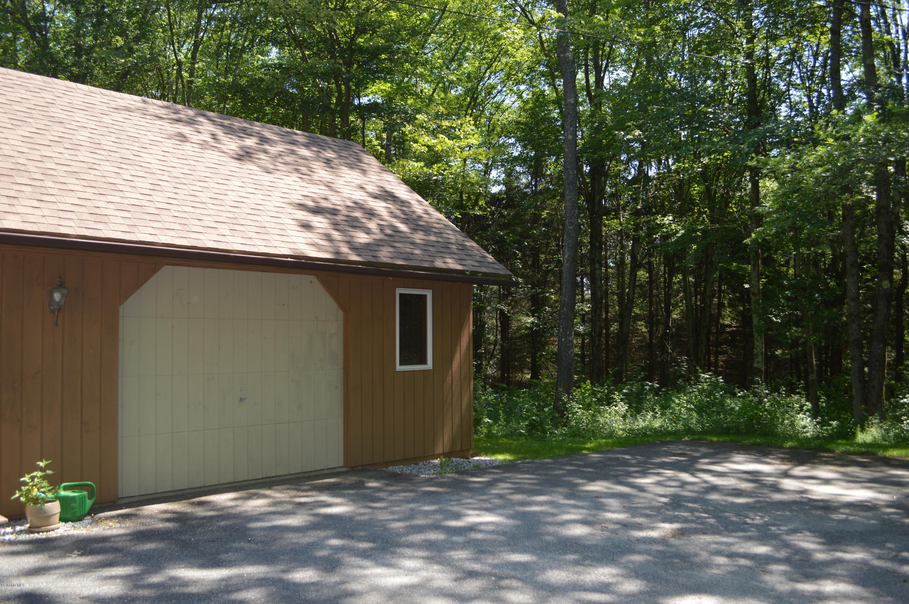 453 Summit Road Richmond, MA 01254 - Photo 24 of 25 a backyard of a house with plants and trees