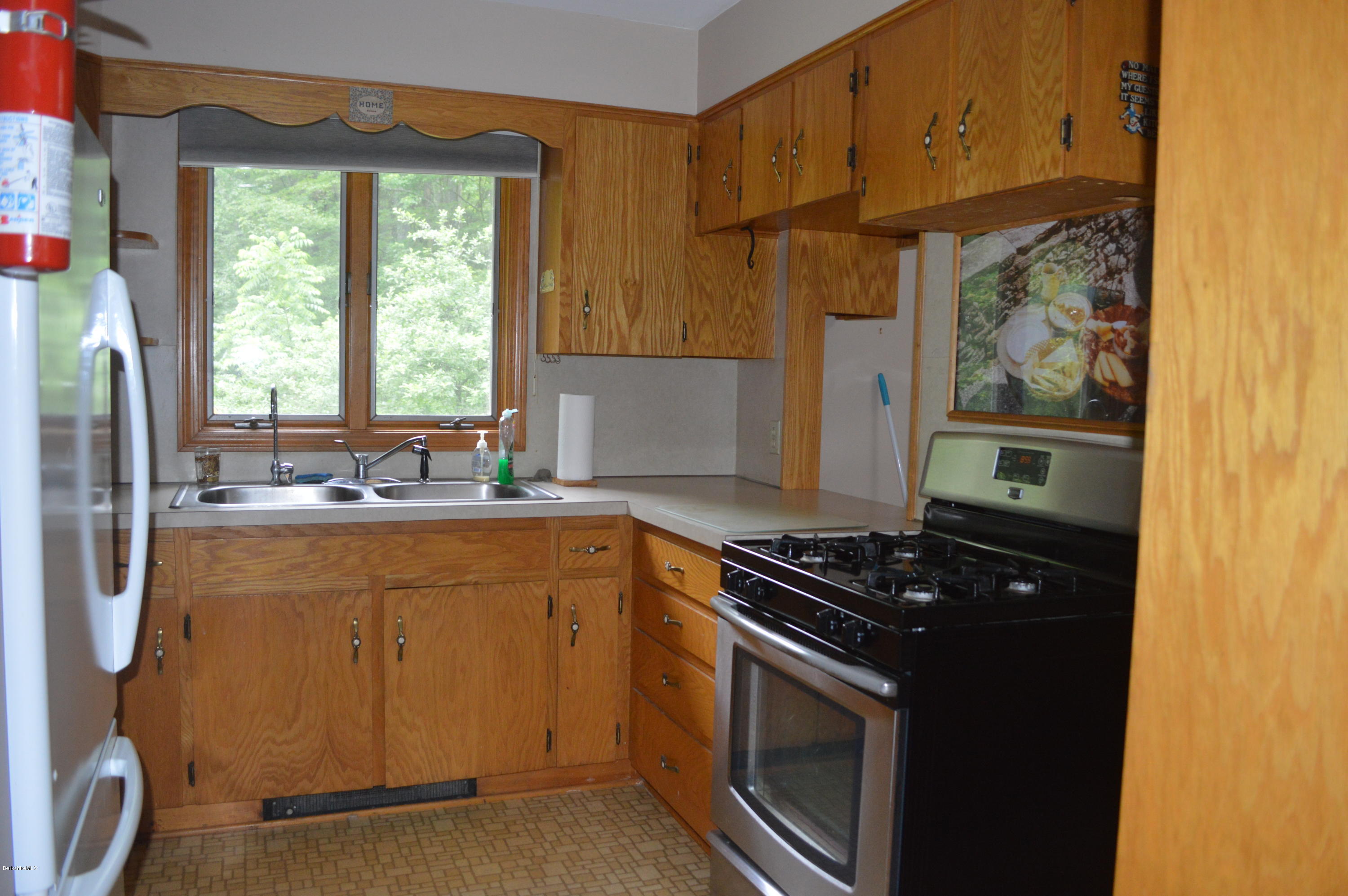 453 Summit Road Richmond, MA 01254 - Photo 7 of 25 a kitchen with stainless steel appliances a stove a sink and a refrigerator