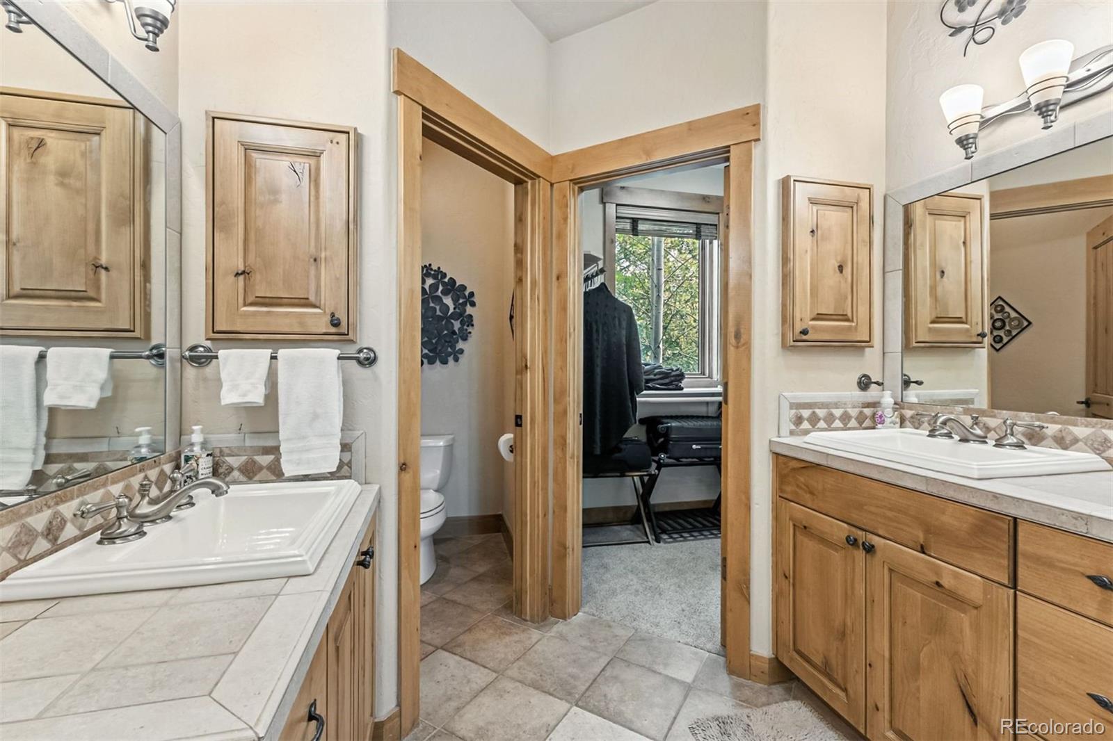 1730 Red Hawk Road Silverthorne, CO 80498 - Photo 32 of 50 a bathroom with a sink a mirror and a bathtub