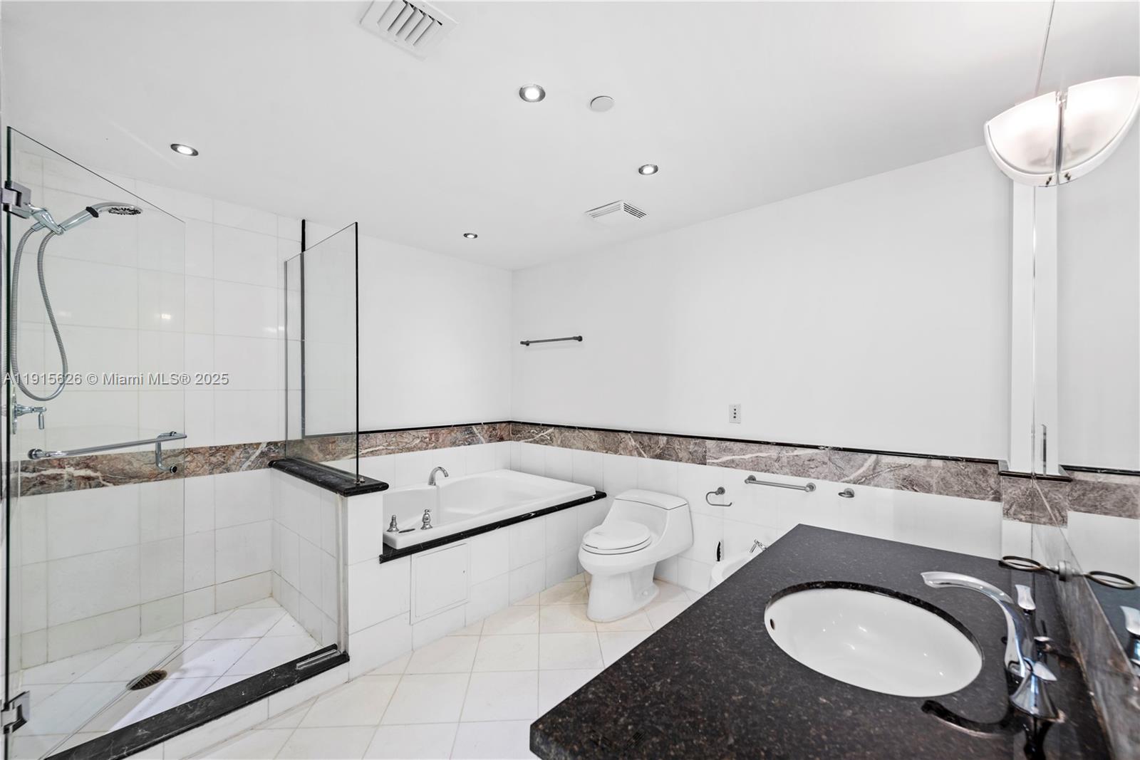 540 West Avenue, Unit 413 Miami Beach, FL 33139 - Photo 20 of 33 a bathroom with a sink and a mirror