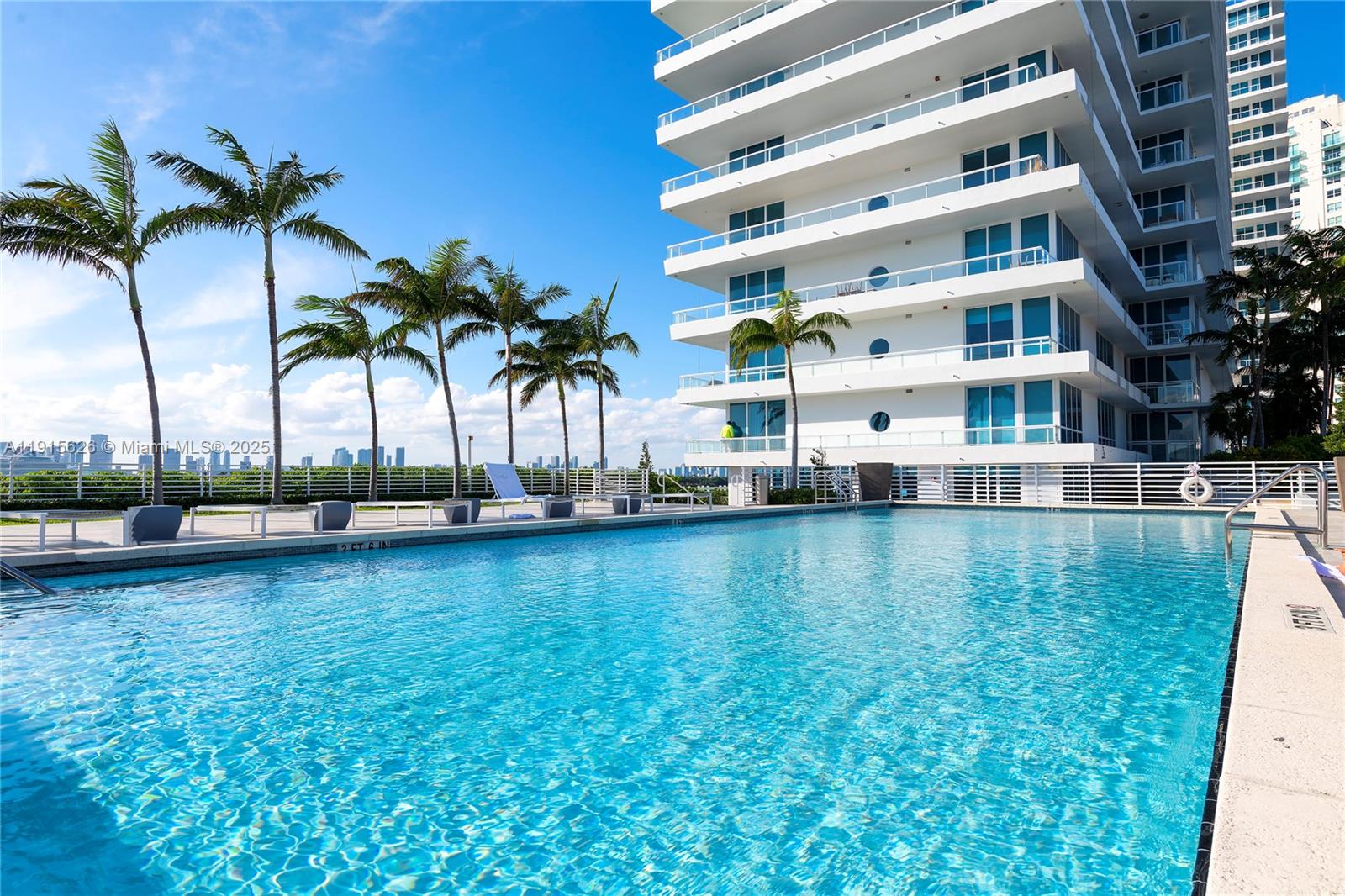 540 West Avenue, Unit 413 Miami Beach, FL 33139 - Photo 31 of 33 a view of a swimming pool with outdoor seating and house in the background