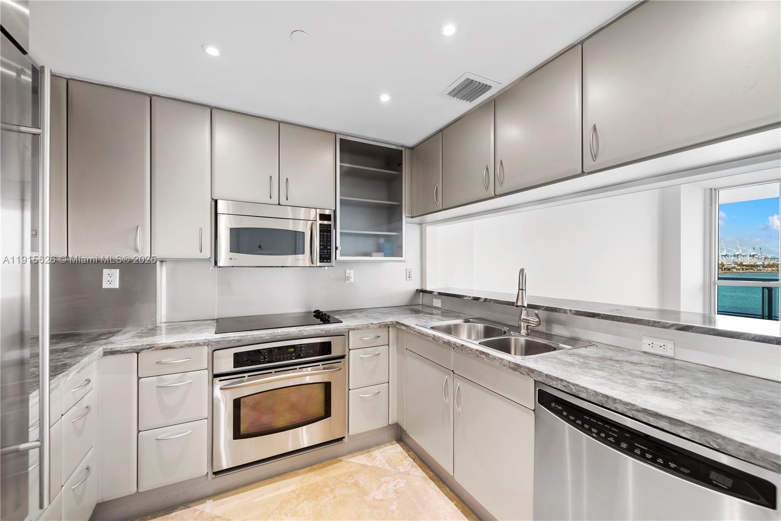 540 West Avenue, Unit 413 Miami Beach, FL 33139 - Photo 8 of 33 a kitchen with stainless steel appliances granite countertop a sink and cabinets