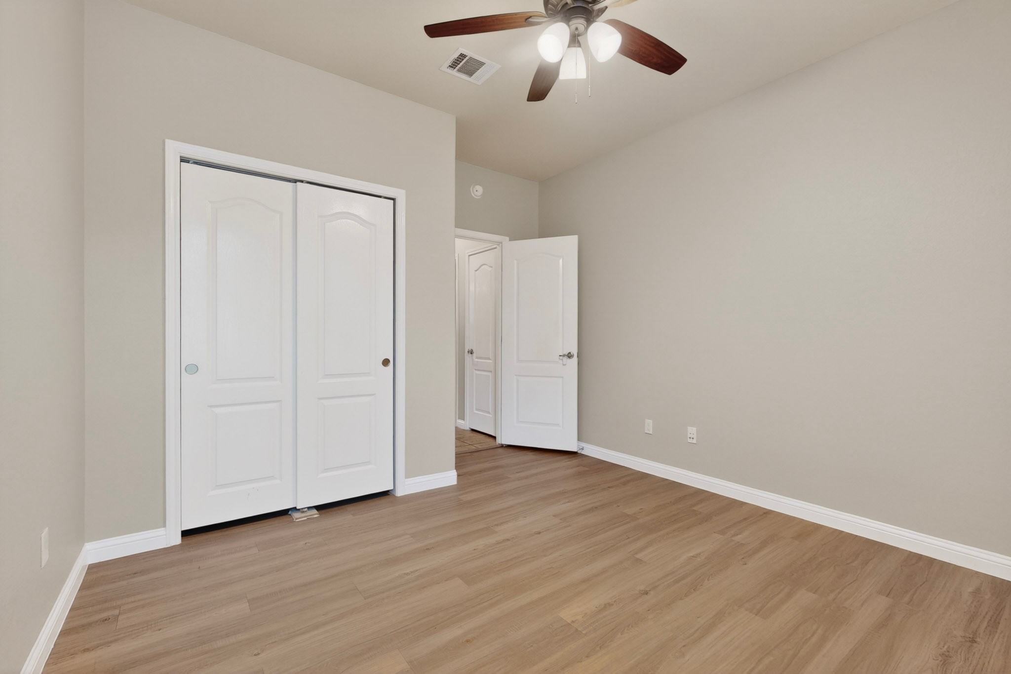 178 Limestone Trail Austin, TX 78737 - Photo 26 of 40 Room featuring wood-finish flooring, light neutral wall paint, and white baseboards