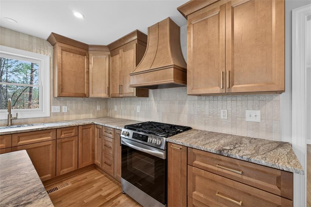 3110 Flatbottom Road Ball Ground, GA 30107 - Photo 23 of 89 a kitchen with granite countertop cabinets stainless steel appliances and a sink