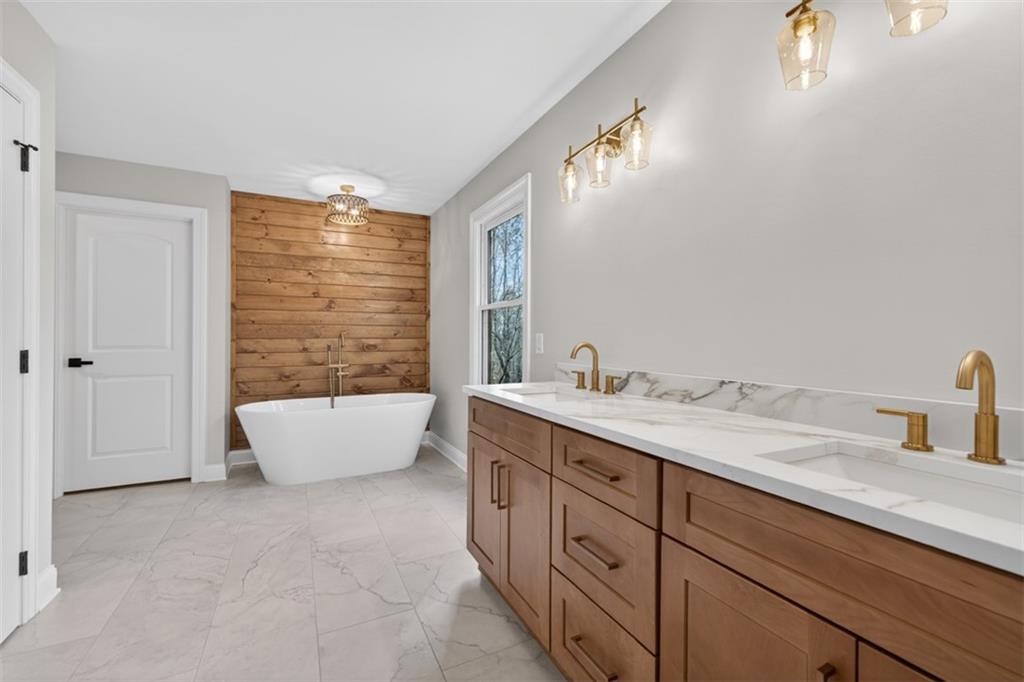 3110 Flatbottom Road Ball Ground, GA 30107 - Photo 34 of 89 a spacious bathroom with a granite countertop sink and a bathtub
