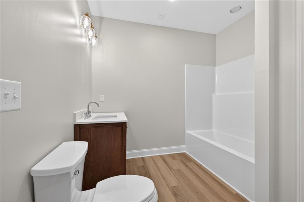 3110 Flatbottom Road Ball Ground, GA 30107 - Photo 65 of 89 a bathroom with a toilet a sink and bathtub