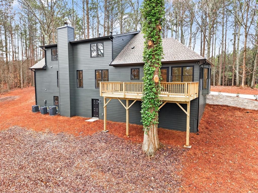 3110 Flatbottom Road Ball Ground, GA 30107 - Photo 76 of 89 a front view of a house with a yard and garage