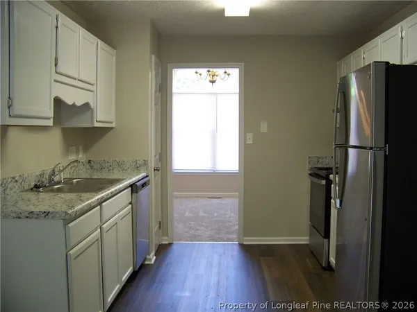 a kitchen with a sink a refrigerator and a stove