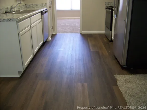 a hallway view with wooden floor