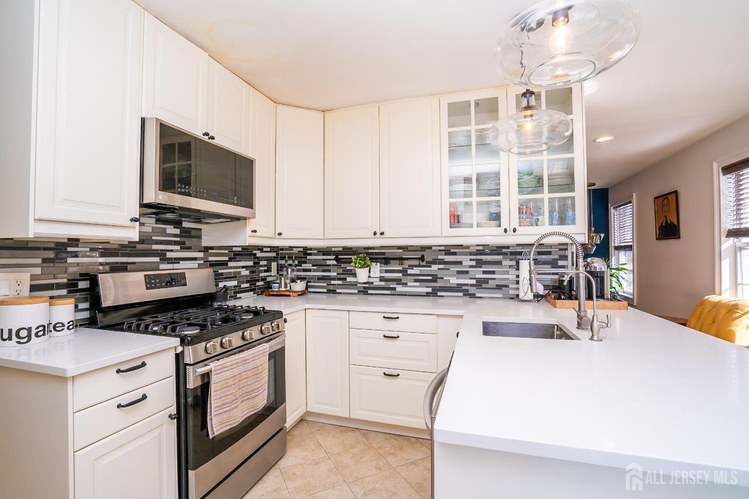 43 Springfield Road North Brunswick, NJ 08902 - Photo 20 of 48 a kitchen with granite countertop a stove and a sink