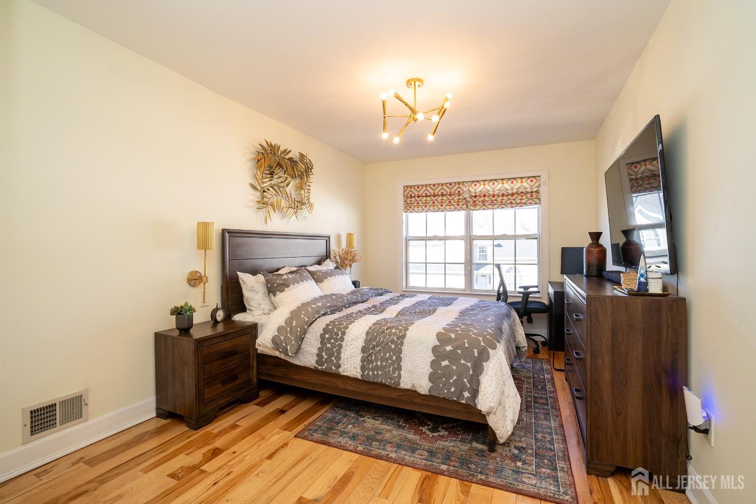 43 Springfield Road North Brunswick, NJ 08902 - Photo 23 of 48 a bedroom with a bed and wooden floor