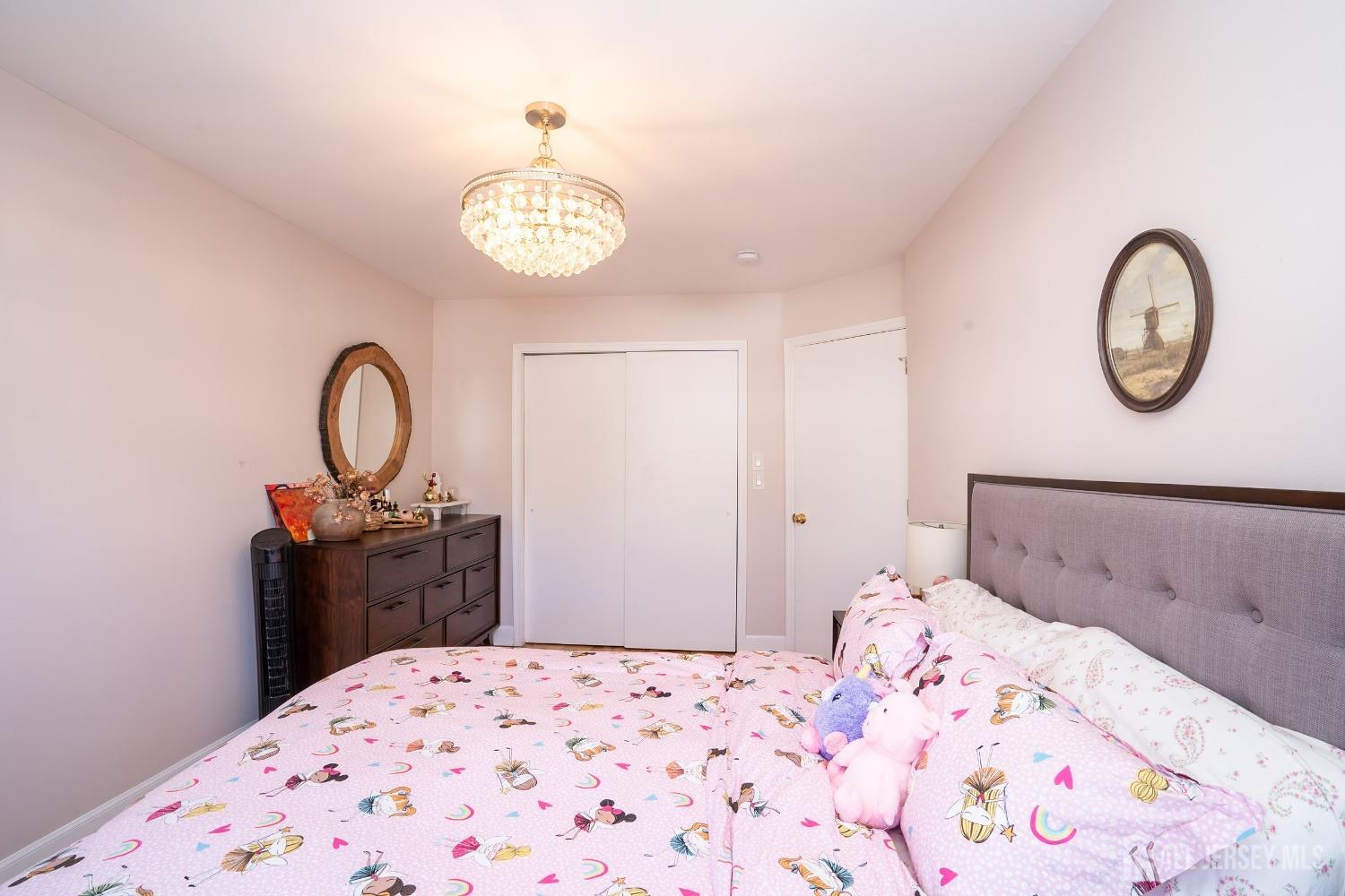 43 Springfield Road North Brunswick, NJ 08902 - Photo 26 of 48 a bedroom with a bed and a dresser with wooden floor
