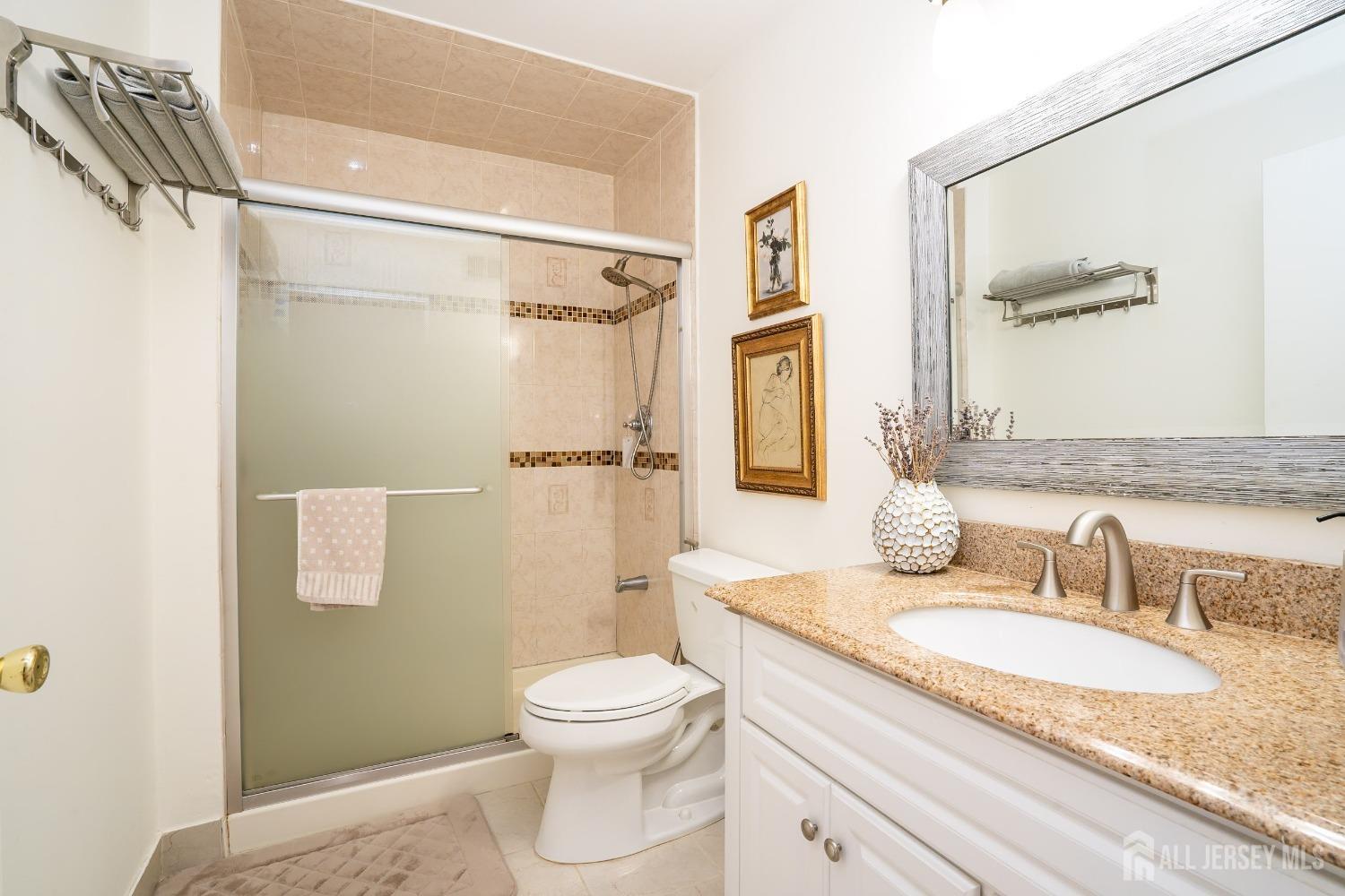 43 Springfield Road North Brunswick, NJ 08902 - Photo 27 of 48 a bathroom with a granite countertop sink toilet and shower