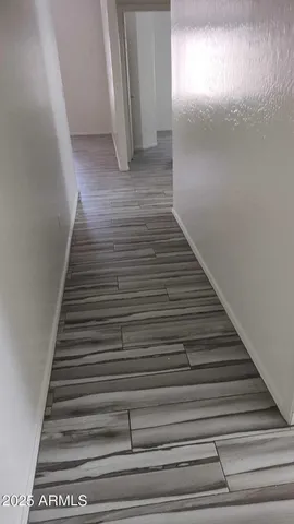 a view of a room with wooden floor