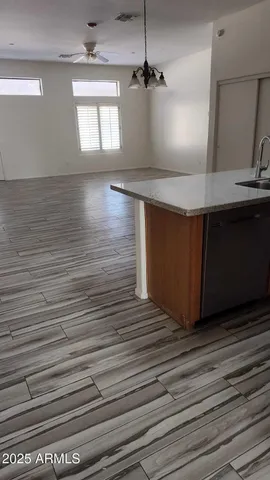 a kitchen with stainless steel appliances granite countertop a sink window and wooden floor