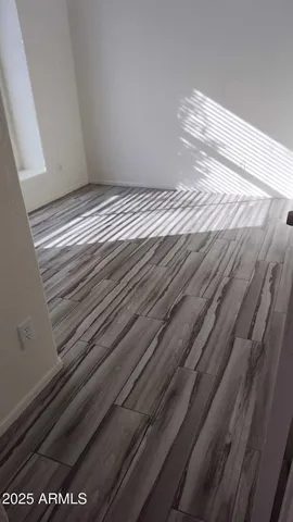 a view of bedroom with wooden floor