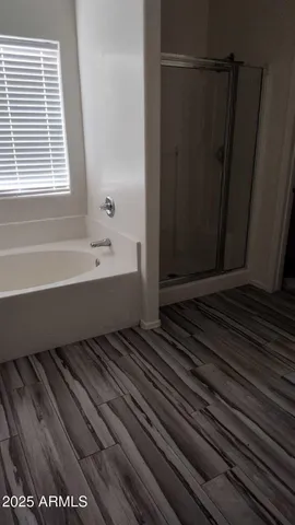 a bathroom with a bathtub and shower