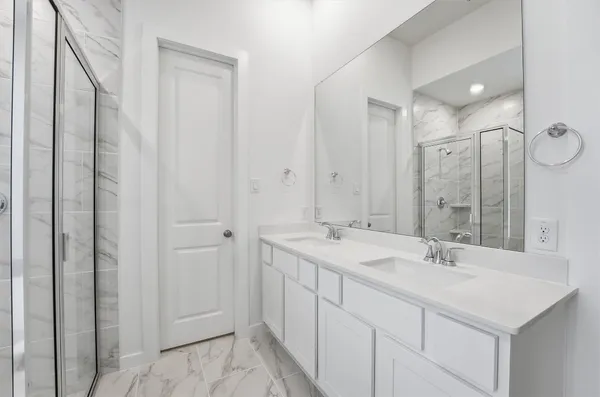a bathroom with a double vanity sink and mirror