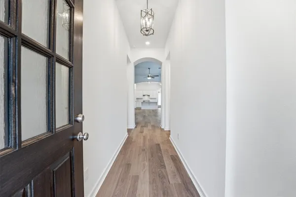 a view of a hallway with wooden floor