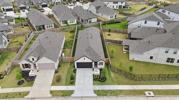 an aerial view of residential houses with outdoor space