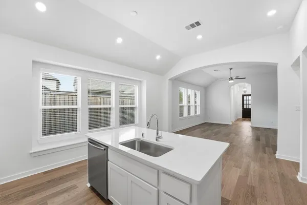 a kitchen with sink and refrigerator