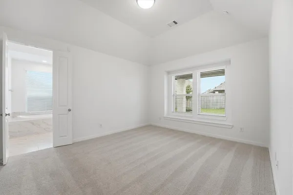 an empty room with windows and closet