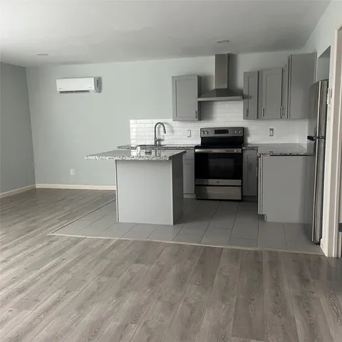 a kitchen with a sink cabinets and stainless steel appliances