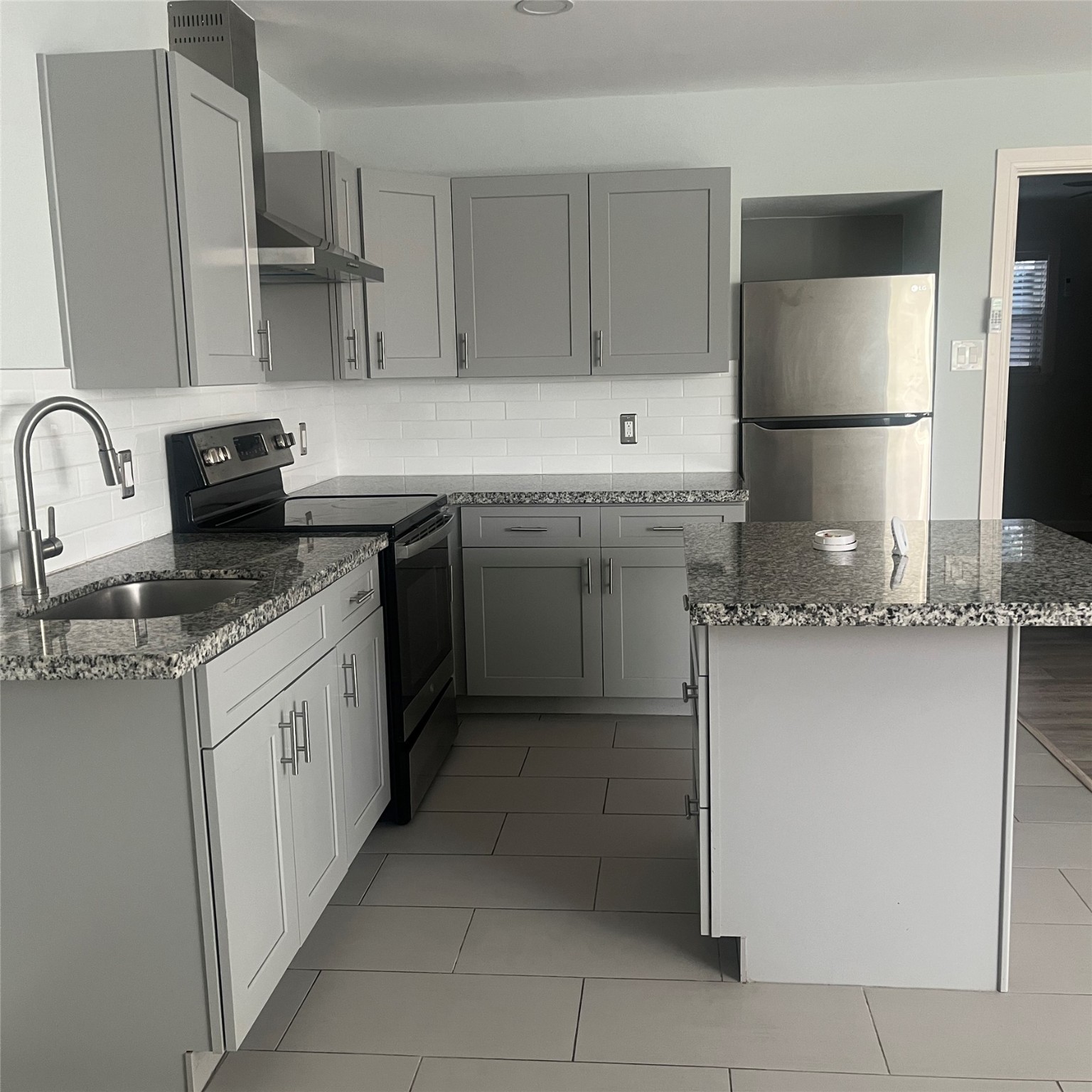 4626 Bell Street, Unit 4 Houston, TX 77023 - Photo 6 of 10 a kitchen with stainless steel appliances granite countertop a sink stove and refrigerator