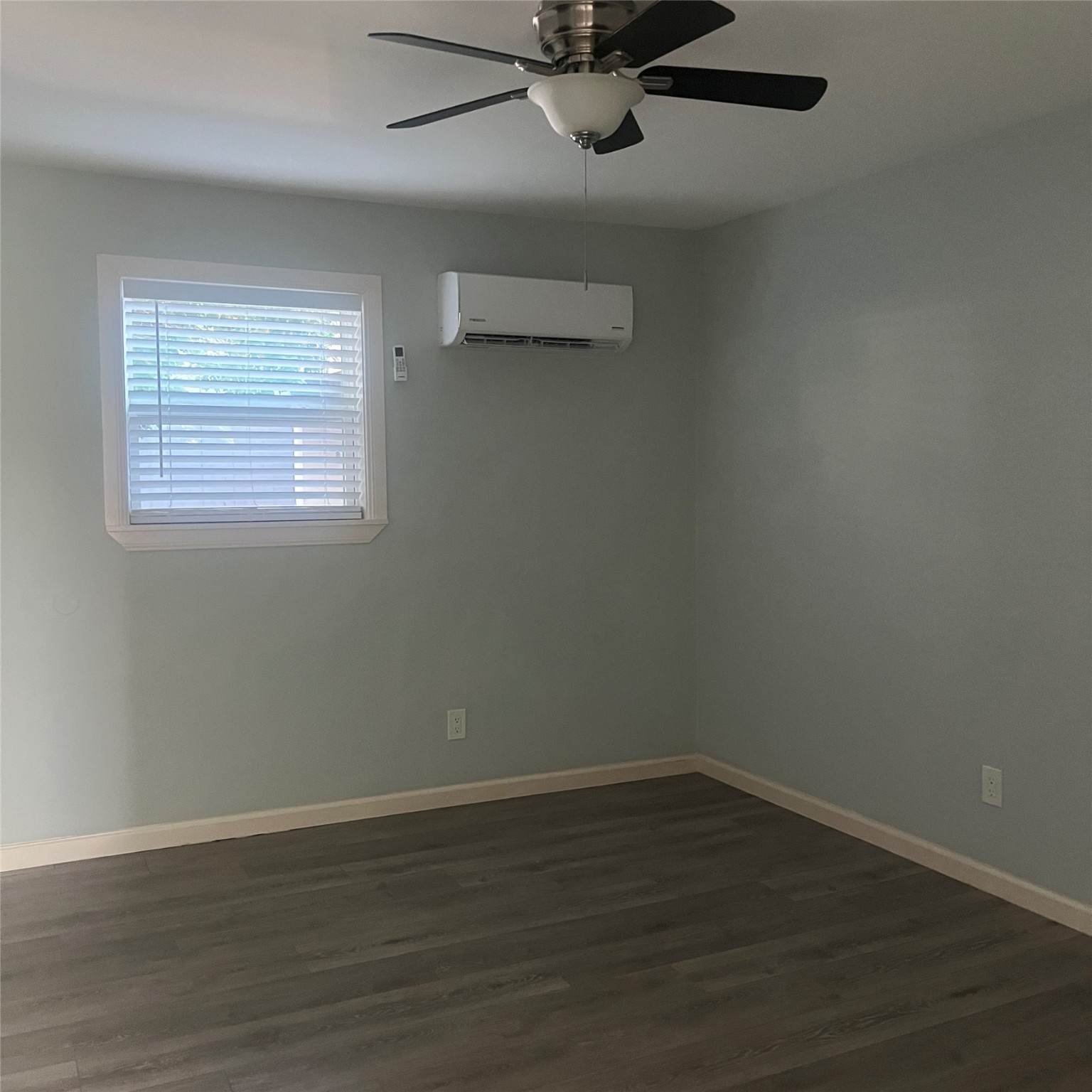 4626 Bell Street, Unit 4 Houston, TX 77023 - Photo 7 of 10 wooden floor in an empty room with a window