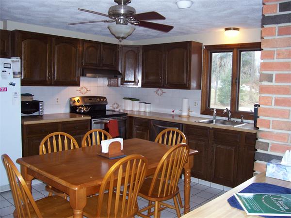 3 Greybirch Road Andover, MA 01810 - Photo 5 of 13 a kitchen with granite countertop a stove a sink a dining table and chairs