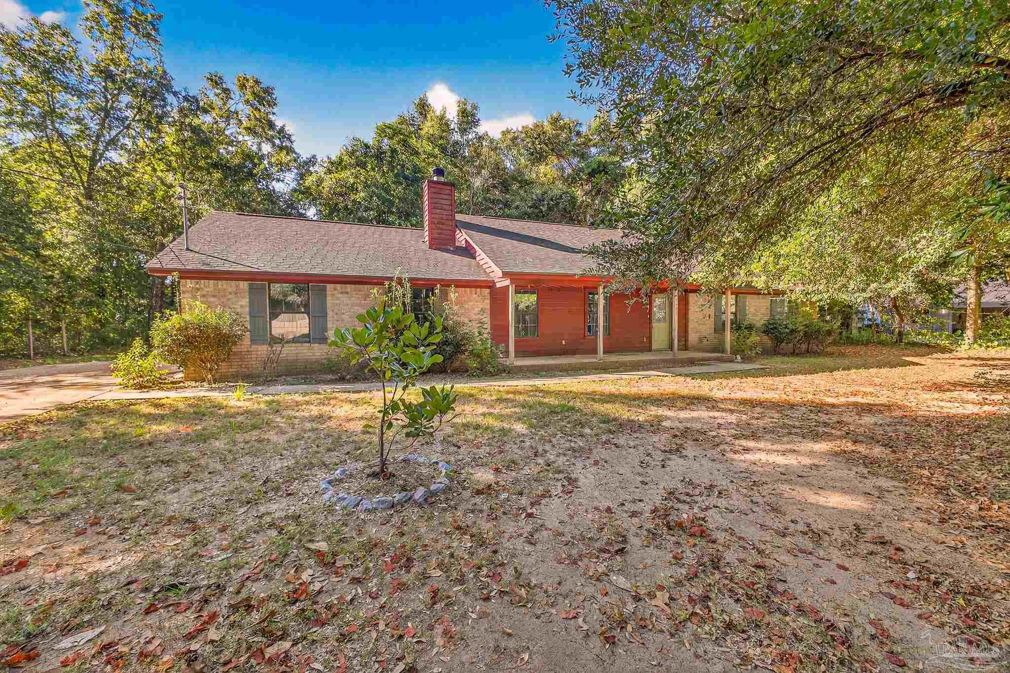 a house that has a tree in front of it
