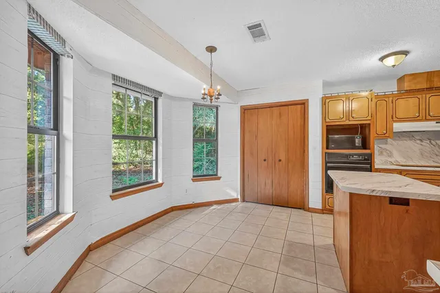 a kitchen with stainless steel appliances granite countertop a sink and a refrigerator