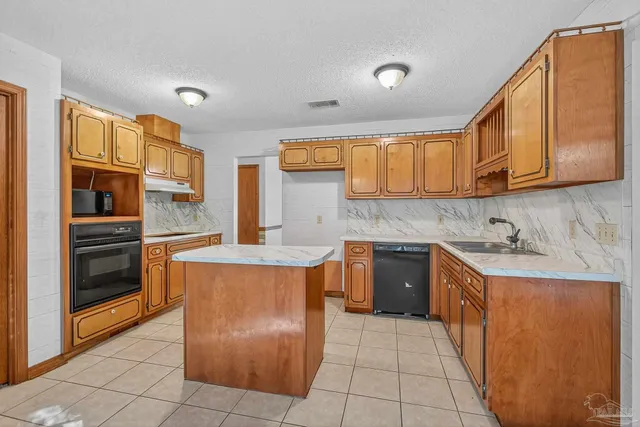 a kitchen with stainless steel appliances granite countertop a sink and cabinets