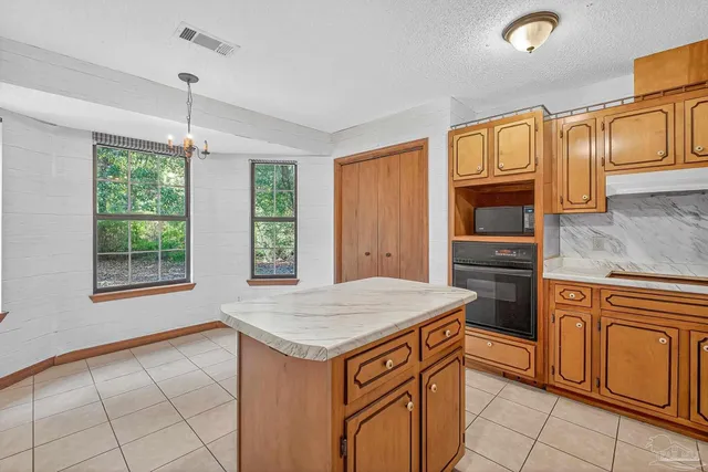 a kitchen with stainless steel appliances granite countertop a stove and a microwave