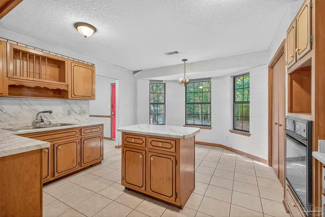 a kitchen with stainless steel appliances granite countertop a stove and a refrigerator